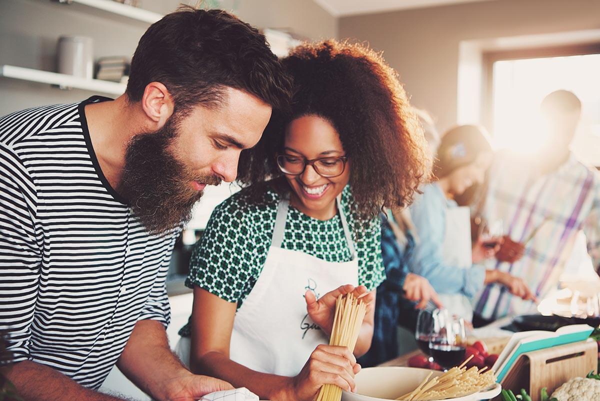 Woman and Man Happily Making Food Together