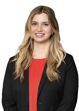 Dr. Rachel Newland, caucasian woman with blonde hair wearing a black jacket and red blouse
