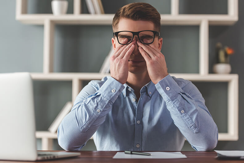 Man Rubbing His Eyes